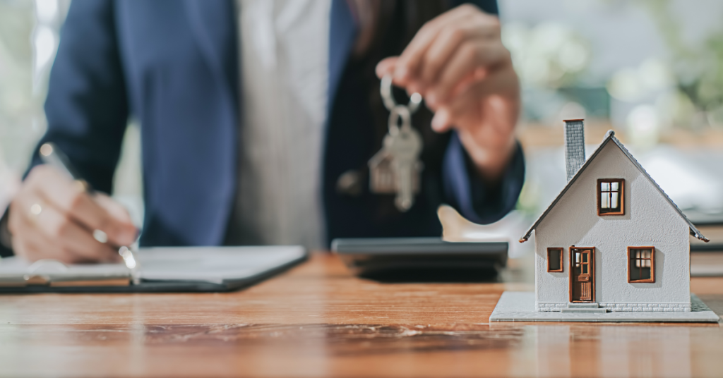 mortgage refinancing little house with man holding key